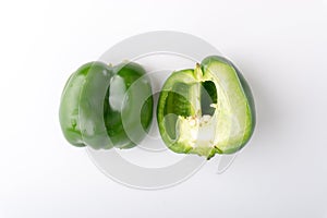 Fresh green bell peppers capsicum on a white background.