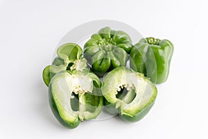 Fresh green bell peppers capsicum on a white background.