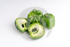 Fresh green bell peppers capsicum on a white background.