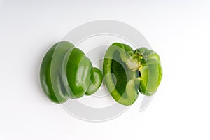 Fresh green bell peppers capsicum on a white background.