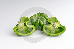 Fresh green bell peppers capsicum on a white background.