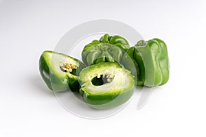 Fresh green bell peppers capsicum on a white background.