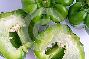 Fresh green bell peppers capsicum on a white background.