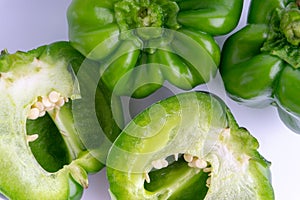 Fresh green bell peppers capsicum on a white background.