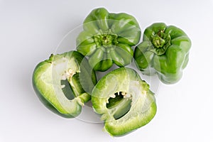 Fresh green bell peppers capsicum on a white background.