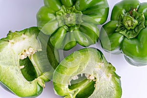 Fresh green bell peppers capsicum on a white background.