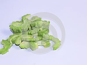 Fresh green bitter gourd on a white background. One of the vegetables has many benefits even though it tastes bitter