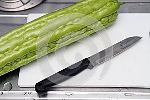 Fresh green bitter melon or bitter gourd ready to cook