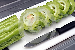 Fresh green bitter melon or bitter gourd sliced ready to cook