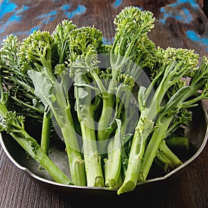 Fresh green broccoli in a metal plate.