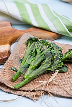 Fresh green broccolini on table