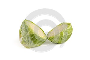Fresh green Brussels sprouts on a white background. Brussels sprouts cut in half casts a shadow on white isolate