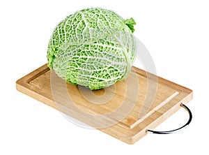 Fresh green cabbage head on wooden chopping board