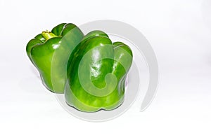 Fresh green capsicum over white isolated background