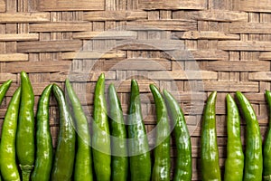 Fresh green chilli paste on bamboo background. Thai spices.