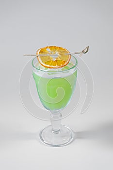 fresh green cocktail with pisang liquor and orange isolated