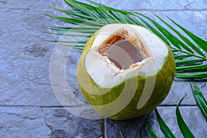 Fresh green coconut fruit and coconut leaves