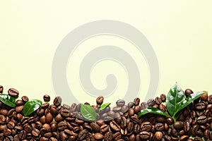 Fresh green coffee leaves and beans on light green background, flat lay