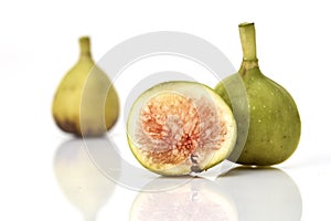 Fresh green figs on white background