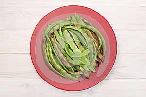 Fresh green flat beans in plate