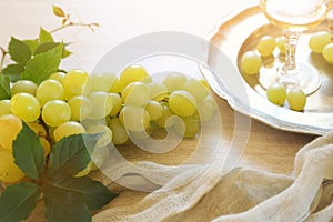 Fresh green grapes and glass of white wine