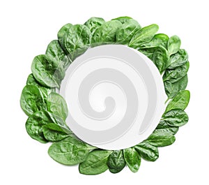 Fresh green healthy baby spinach leaves and blank card on white background, top view