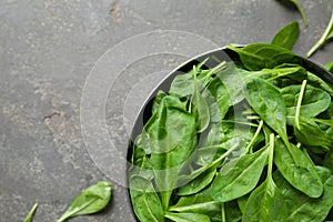 Fresh green healthy spinach on grey table, top view