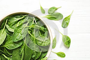 Fresh green healthy spinach on white wooden table. Space for text