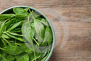 Fresh green healthy spinach on wooden table. Space for text