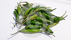 Fresh green hot chili or cabe rawit hijau on white background