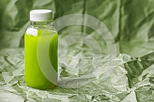 Fresh green juice in eco-friendly recyclable plastic bottle and packaging, healthy drink and food product