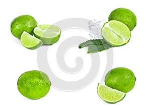 Fresh green juicy limes, lime slices, ice and mint leaves set isolated on white background.