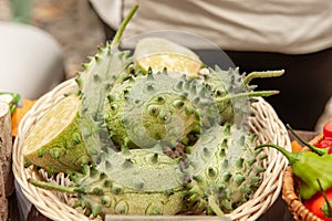 Fresh green kiwano fruits lie in a basket on the counter of the farmer`s market. Exotic fruit