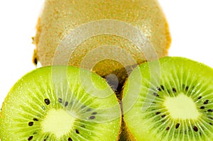 Fresh green kiwi fruit slice close up partially isolated on white background with selective focus, view from above