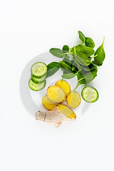 Fresh green leaves spinach, slices of cucumber and ginger isolated on a white background. Copy space for text. Healthy