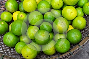 Fresh green limes in wooden basket