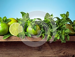 Fresh green mint and limes on a old wooden table