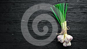 Fresh green onion on a wooden background.