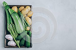 Fresh green organic vegetables in a wooden box