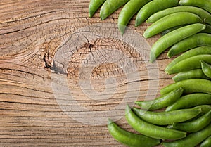 Fresh green pea pods on Wooden background