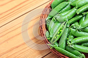 Fresh green peas in a basket