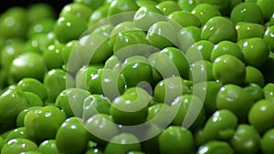 Fresh green peas on black background gyrating