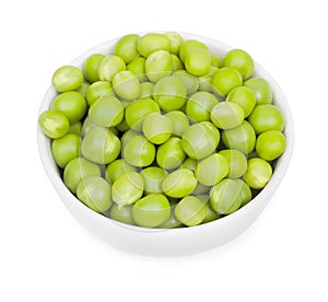 Fresh green peas in a litlle white ceramic bowl. Isolated on white background, close-up, top view