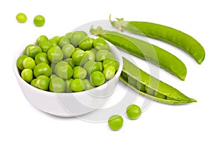 Fresh green peas in a little white bowl, fresh pea`s pods, open and closed. Isolated on white background, close-up
