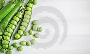 Fresh green peas in pods. Horizontal background. Background with copy space. Horizontal. Top view.
