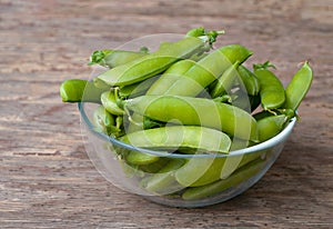 Fresh Green peas. Top view. Pea on wooden background