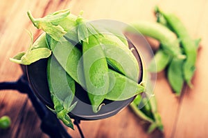 Fresh green peas on vintage scales