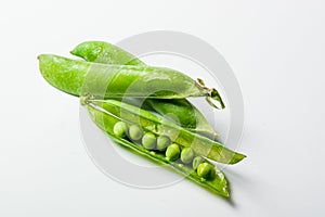 Fresh green peas on white background