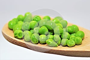 Fresh green peas on wood spoon food nutrition agricolture organic nature