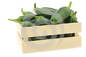 Fresh green peppers(capsicum) in a wooden box